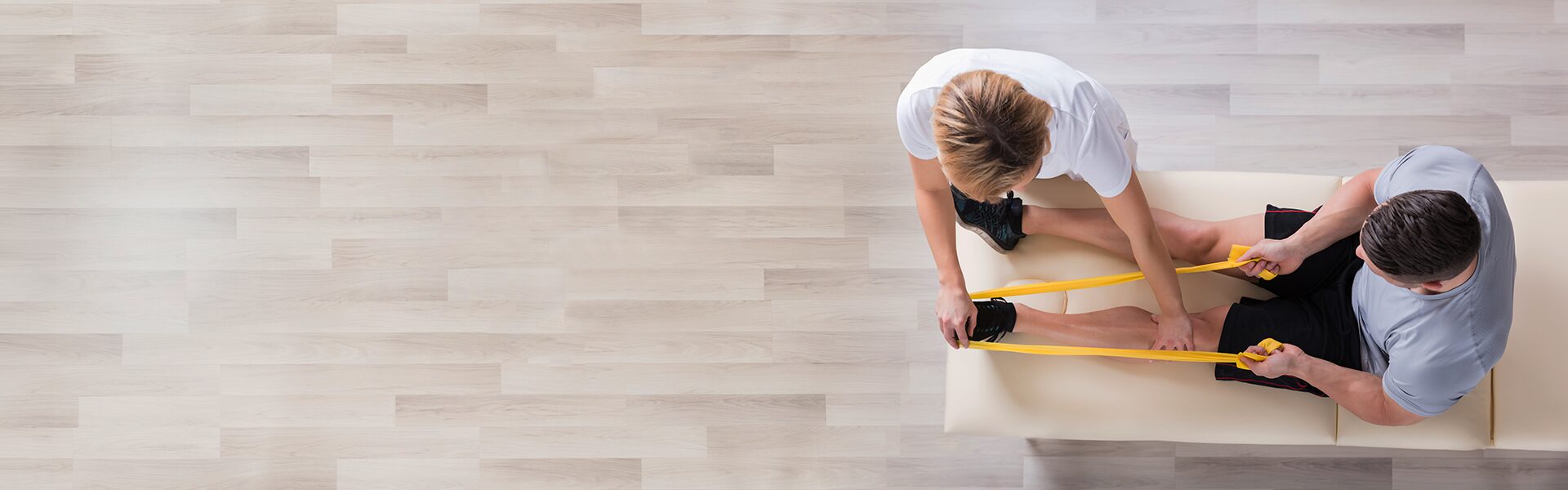 Billede af fysioterapeut der hjælper patient med øvelser